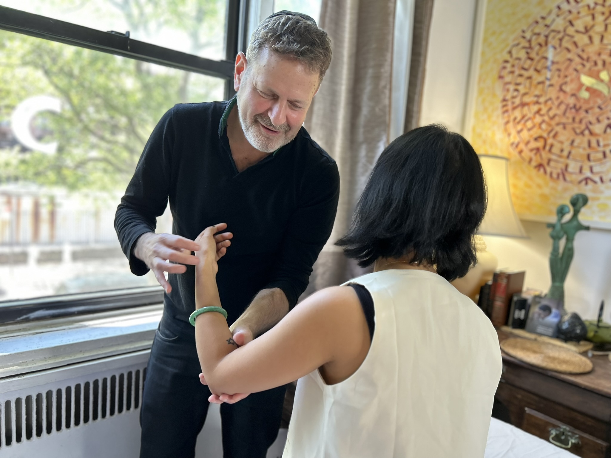 Noam guiding a client through movement work